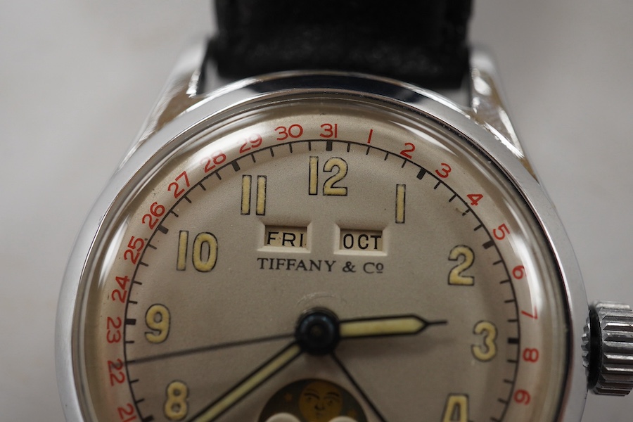 A gentleman's 1940's? steel calandar moonphase manual wind wrist watch, the dial inscribed Tiffany & Co, with Arabic dial and day/date apertures, case diameter 33mm, on a later associated leather strap, movement unsigned